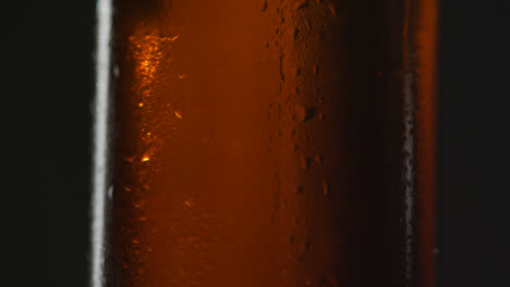 Pull-Focus-Shot-Of-Close-Up-Of-Condensation-Droplets-On-Bottle-Of-Cold-Beer-Or-Soft-Drink